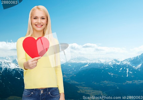 Image of smiling woman with red heart