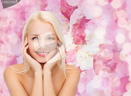 Image of beautiful woman touching her face skin