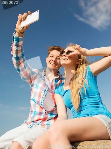 Image of smiling couple having fun outdoors