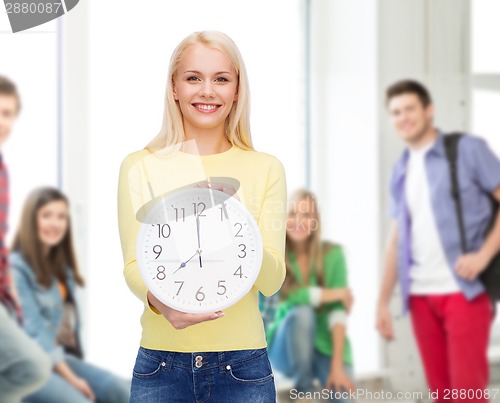 Image of student with wall clock