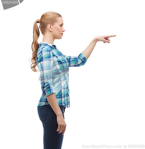 Image of young woman pressing imaginary button