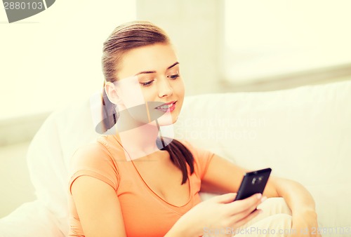 Image of woman with smartphone at home