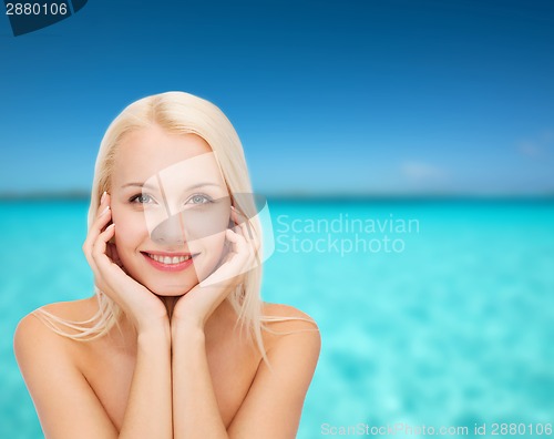 Image of beautiful woman touching her face skin