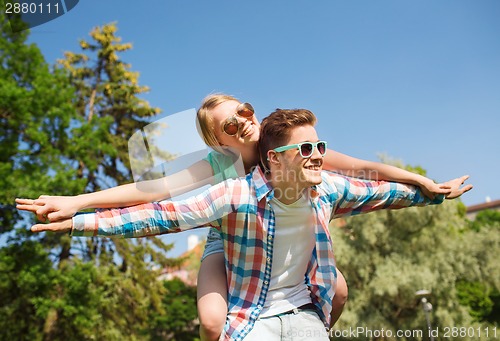 Image of smiling couple having fun in park