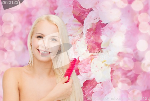Image of smiling woman with hair brush