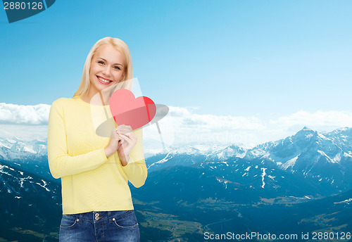 Image of smiling woman with red heart
