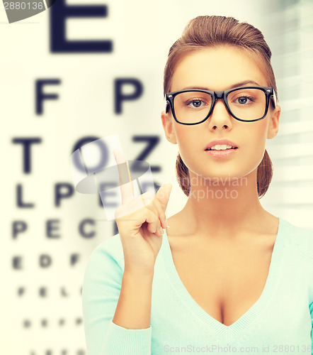 Image of woman in eyeglasses with eye chart