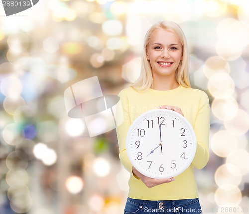 Image of student with wall clock