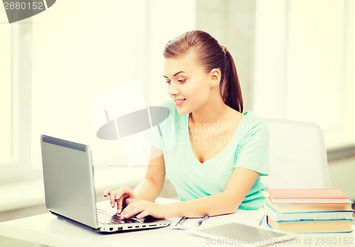 Image of smiling student girl with laptop