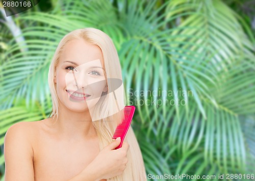 Image of smiling woman with hair brush