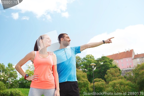 Image of two smiling people outdoors