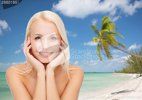 Image of beautiful woman touching her face skin