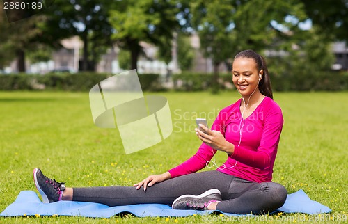 Image of smiling african american woman with smartphone