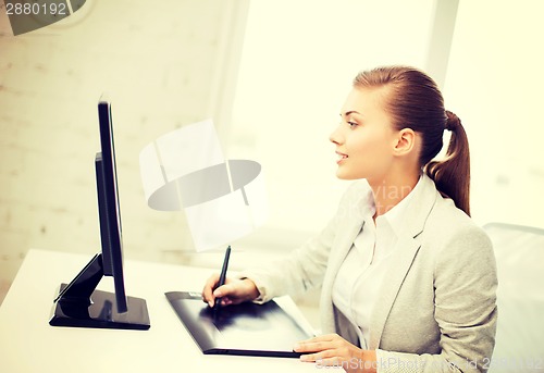 Image of businesswoman with drawing tablet in office