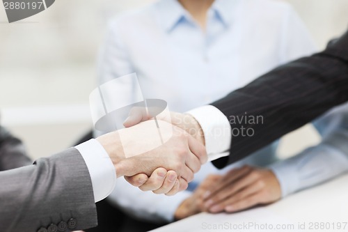 Image of two businessmen shaking hands in office