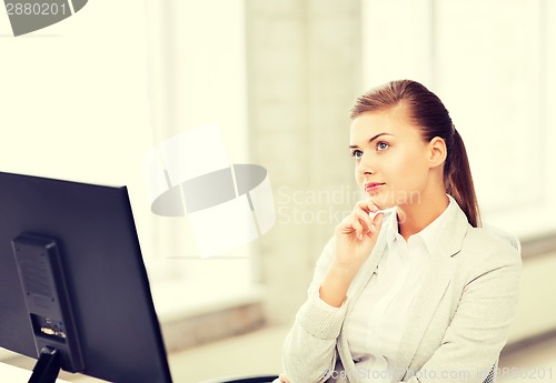 Image of pensive woman in office