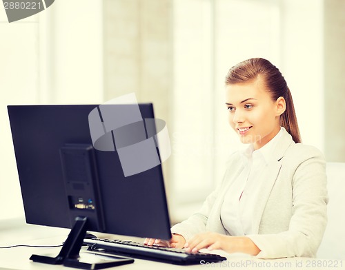 Image of businesswoman with computer in office