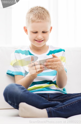 Image of smiling little boy with smartphone