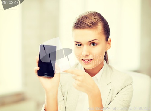 Image of businesswoman with smartphone in office