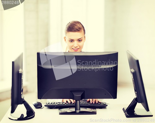 Image of businesswoman with computer and monitors in office