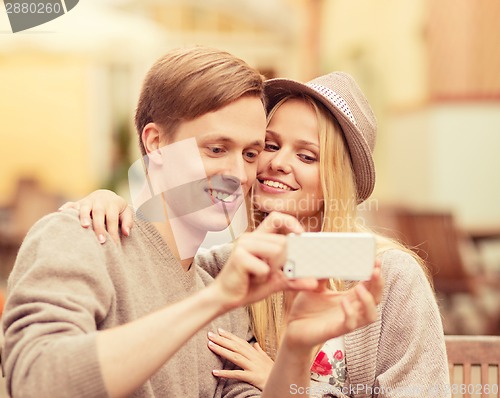 Image of couple taking selfie with smartphone