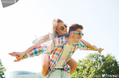 Image of smiling couple having fun in park
