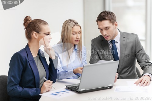 Image of business team with laptop having discussion