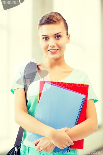 Image of student girl with school bag and notebooks