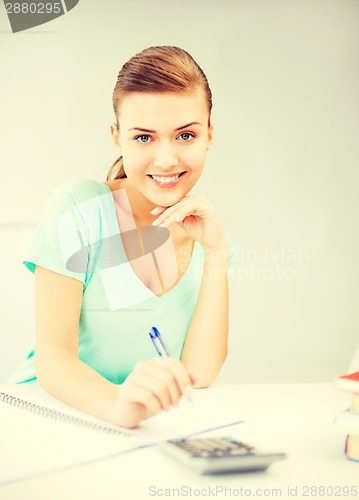 Image of student girl with notebook and calculator