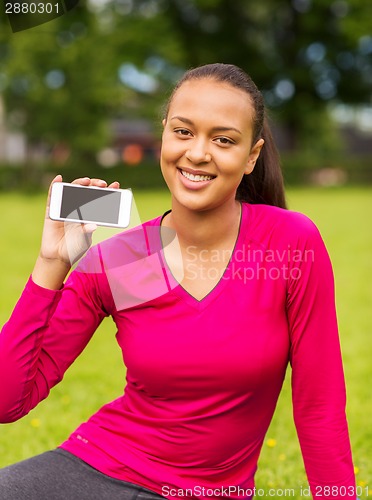 Image of smiling african american woman with smartphone