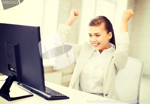 Image of businesswoman with computer in office