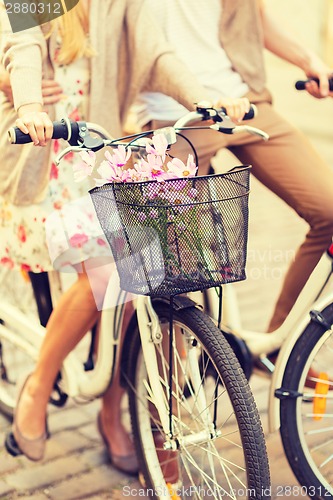 Image of couple with bicycles in the city