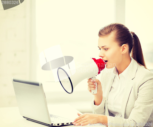 Image of strict businesswoman shouting in megaphone