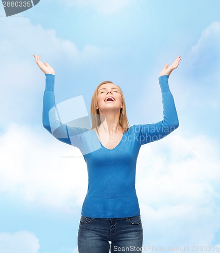 Image of laughing young woman waving hands