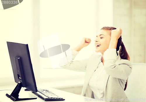 Image of businesswoman with computer in office