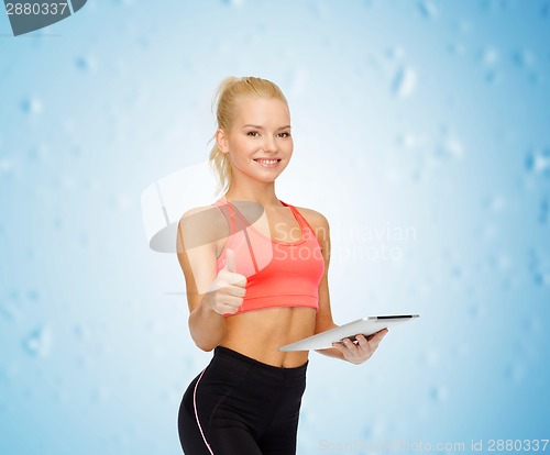 Image of smiling sporty woman with tablet pc computer