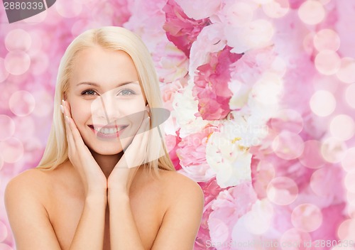Image of beautiful woman touching her face skin