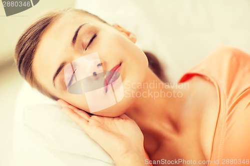 Image of woman sleeping on the couch at home