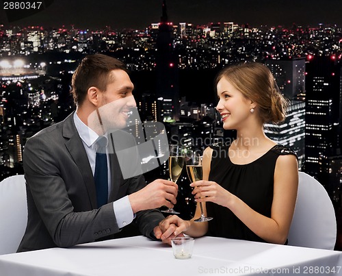 Image of couple with glasses of champagne at restaurant