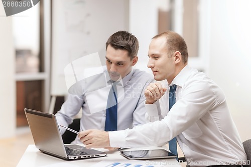 Image of two businessmen having discussion in office