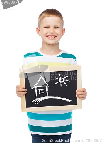 Image of smiling little boy holding chalkboard with home