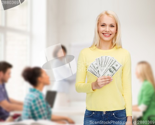 Image of smiling girl with dollar cash money