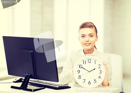 Image of attractive businesswoman with white clock