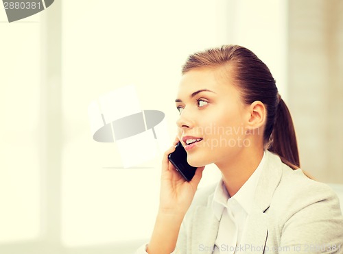 Image of businesswoman with smartphone in office