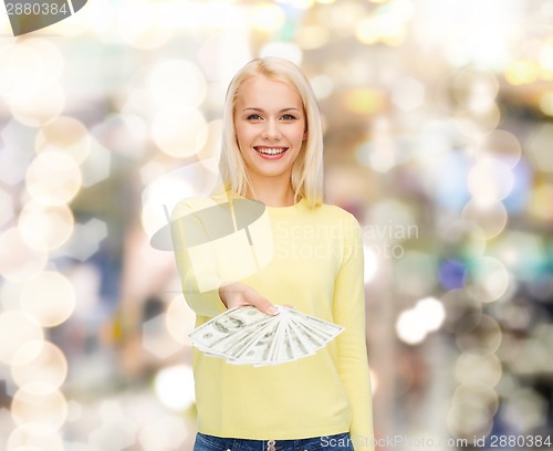 Image of smiling girl with dollar cash money