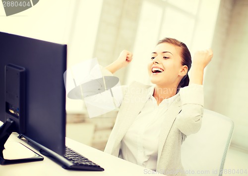 Image of businesswoman with computer in office