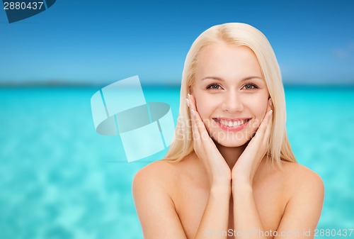 Image of beautiful woman touching her face skin
