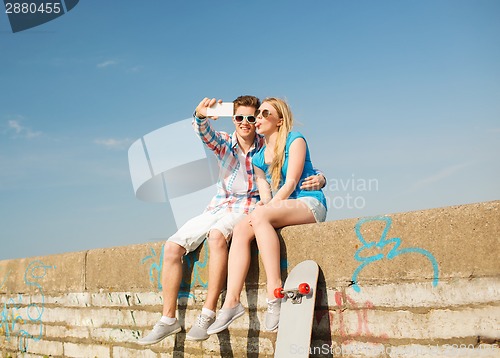 Image of smiling couple having fun outdoors