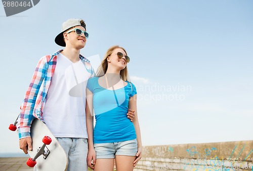 Image of smiling couple having fun outdoors