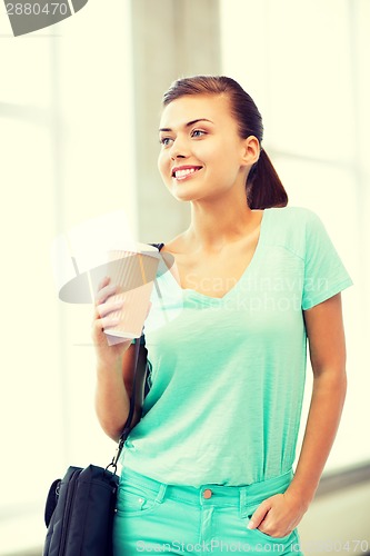 Image of student holding take away coffee cup